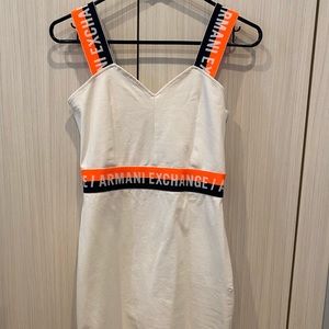 White Armani dress with orange/blue logo design.